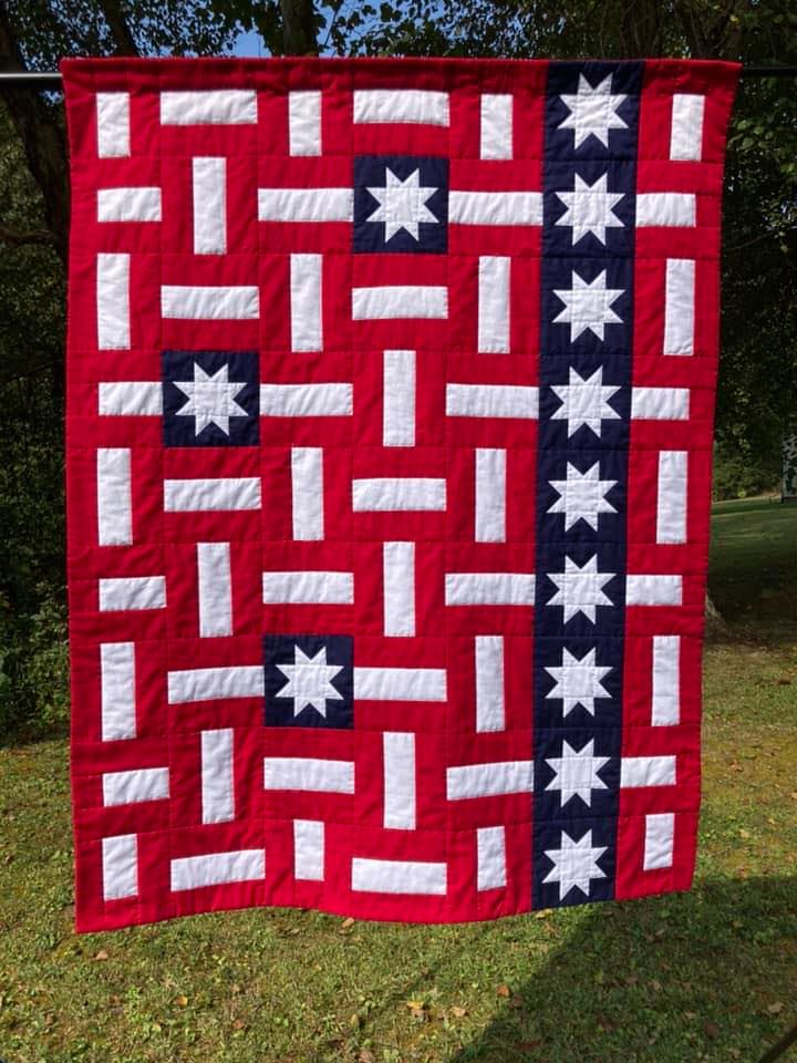 red white and blue quilt with stars